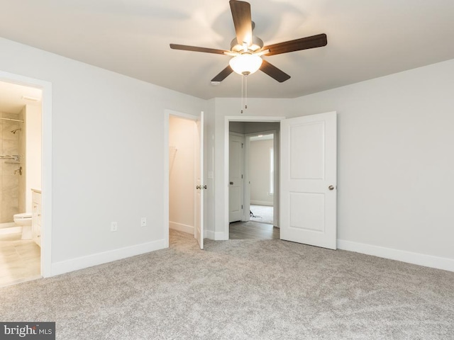 unfurnished bedroom featuring connected bathroom, ceiling fan, a closet, and carpet floors