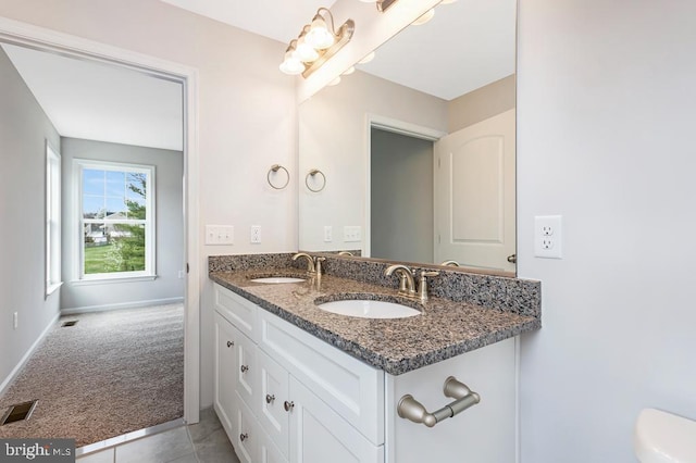 bathroom with tile patterned floors and vanity