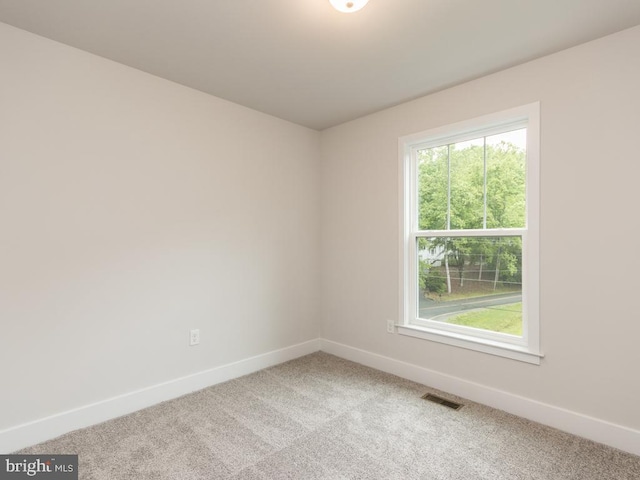 unfurnished room featuring carpet