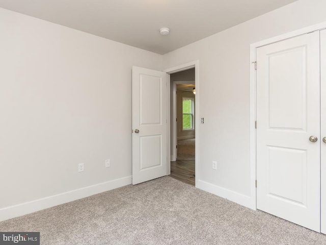 spare room featuring light colored carpet and ceiling fan