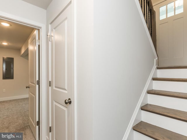 stairs with carpet floors and electric panel