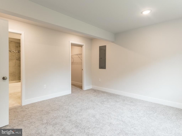 carpeted spare room featuring electric panel