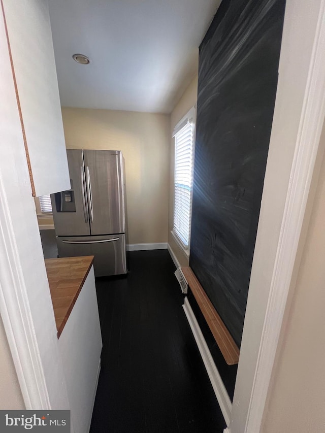 kitchen featuring dark hardwood / wood-style floors and stainless steel fridge