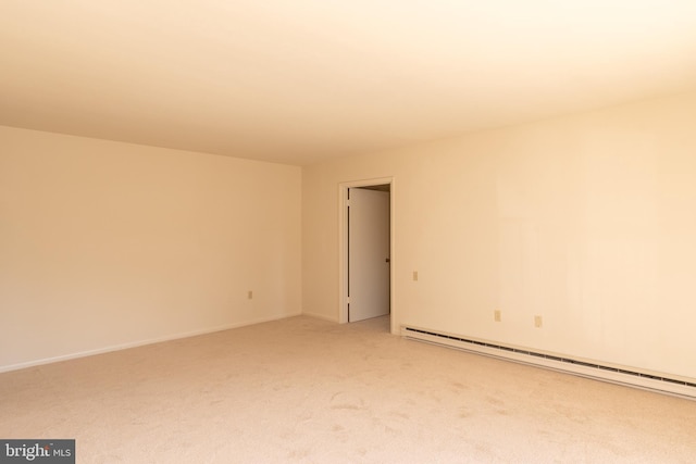 spare room featuring carpet and a baseboard radiator