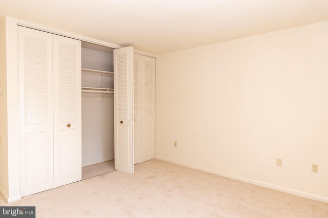 unfurnished bedroom with light colored carpet