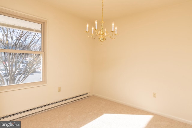 spare room with carpet, a chandelier, and a baseboard heating unit