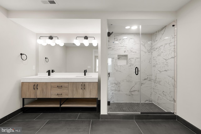 bathroom with tile patterned flooring, vanity, and an enclosed shower