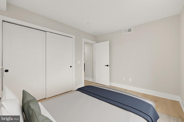 bedroom featuring light wood-type flooring and a closet