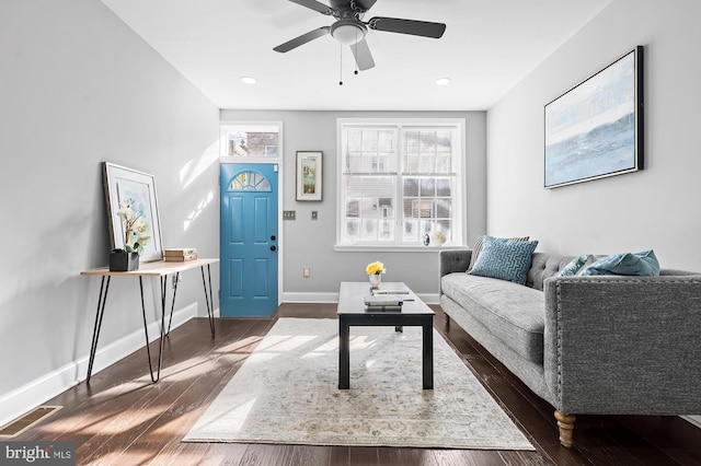 living room with dark hardwood / wood-style flooring and ceiling fan