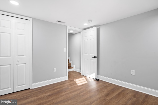 unfurnished bedroom with wood-type flooring and a closet