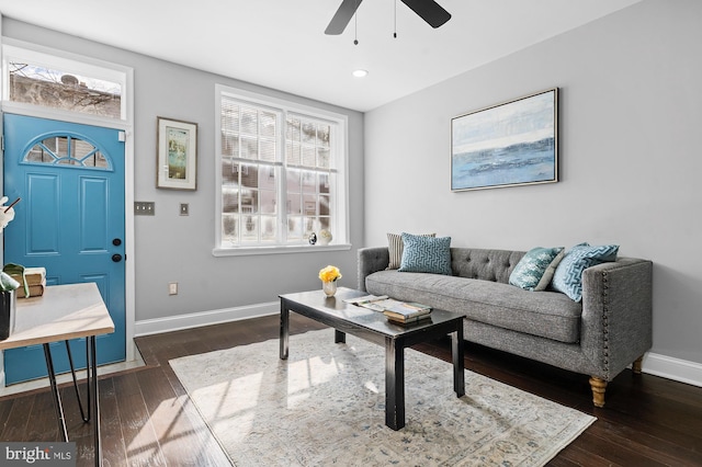 living room featuring dark hardwood / wood-style floors and ceiling fan