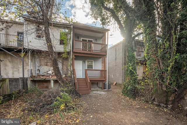 rear view of property with a balcony and central AC unit