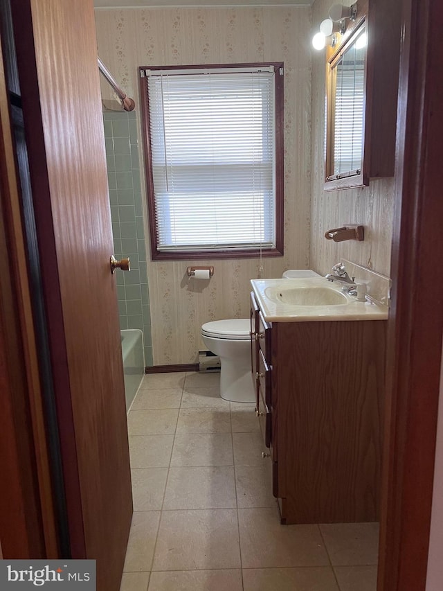 bathroom featuring toilet, vanity, a baseboard radiator, and tile patterned floors