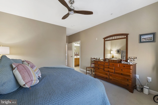 carpeted bedroom featuring ceiling fan and ensuite bathroom