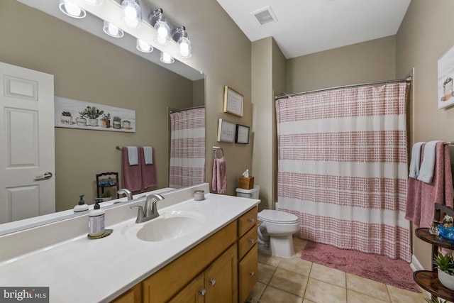 bathroom with tile patterned floors, vanity, curtained shower, and toilet