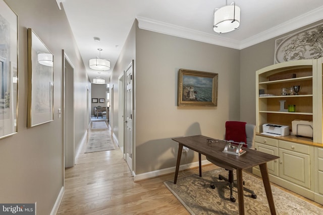 home office with light hardwood / wood-style flooring and crown molding