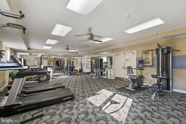 exercise room featuring ceiling fan and dark colored carpet