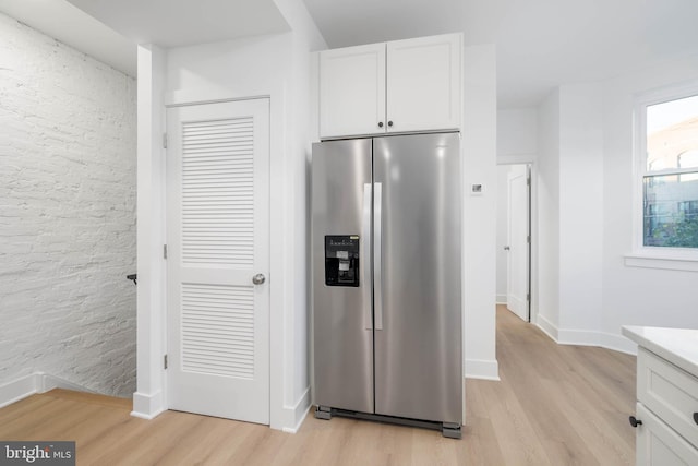 1401 S 13th St, Philadelphia, PA 19147 - kitchen with stainless steel fridge with ice dispenser, light wood-type flooring, white cabinets, and light countertops