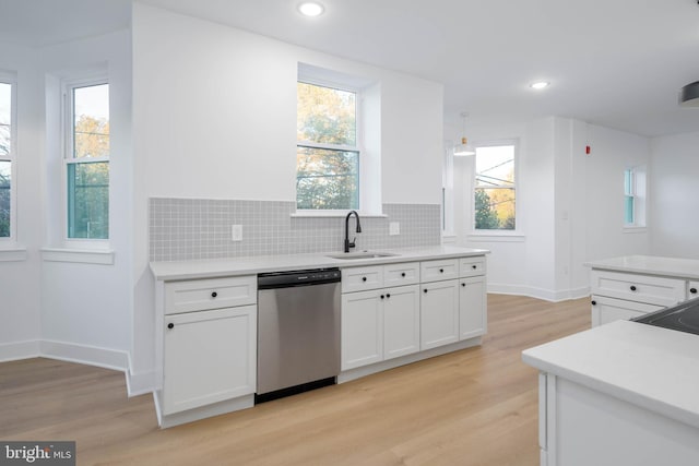 1401 S 13th St, Philadelphia, PA 19147 - kitchen featuring stainless steel dishwasher, a sink, white cabinetry, light wood-style flooring, and recessed lighting