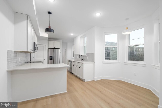 1401 S 13th St, Philadelphia, PA 19147 - kitchen featuring stainless steel appliances, a sink, tasteful backsplash, recessed lighting, and light wood-style flooring