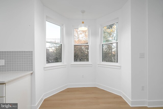 1401 S 13th St, Philadelphia, PA 19147 - unfurnished dining area featuring light wood-type flooring, healthy amount of natural light, and baseboards