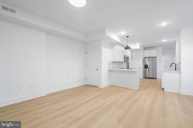 1401 S 13th St, Philadelphia, PA 19147 - unfurnished living room with light wood finished floors, baseboards, recessed lighting, and a sink