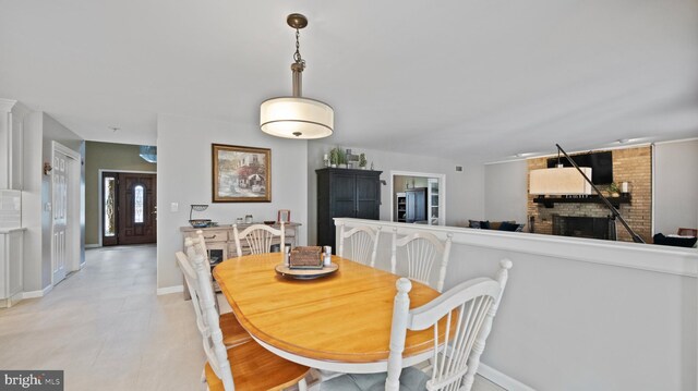 dining room with a brick fireplace