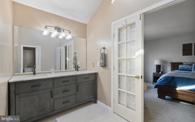 bathroom with vanity and lofted ceiling