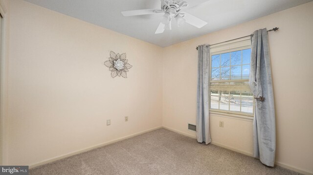 unfurnished room with ceiling fan and light colored carpet