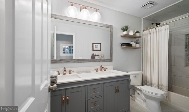 full bathroom with tile patterned flooring, shower / tub combo, vanity, and toilet