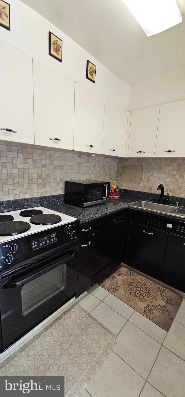 kitchen featuring backsplash, white cabinets, sink, light tile patterned floors, and white electric range oven