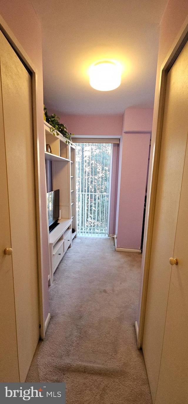 hall with light colored carpet