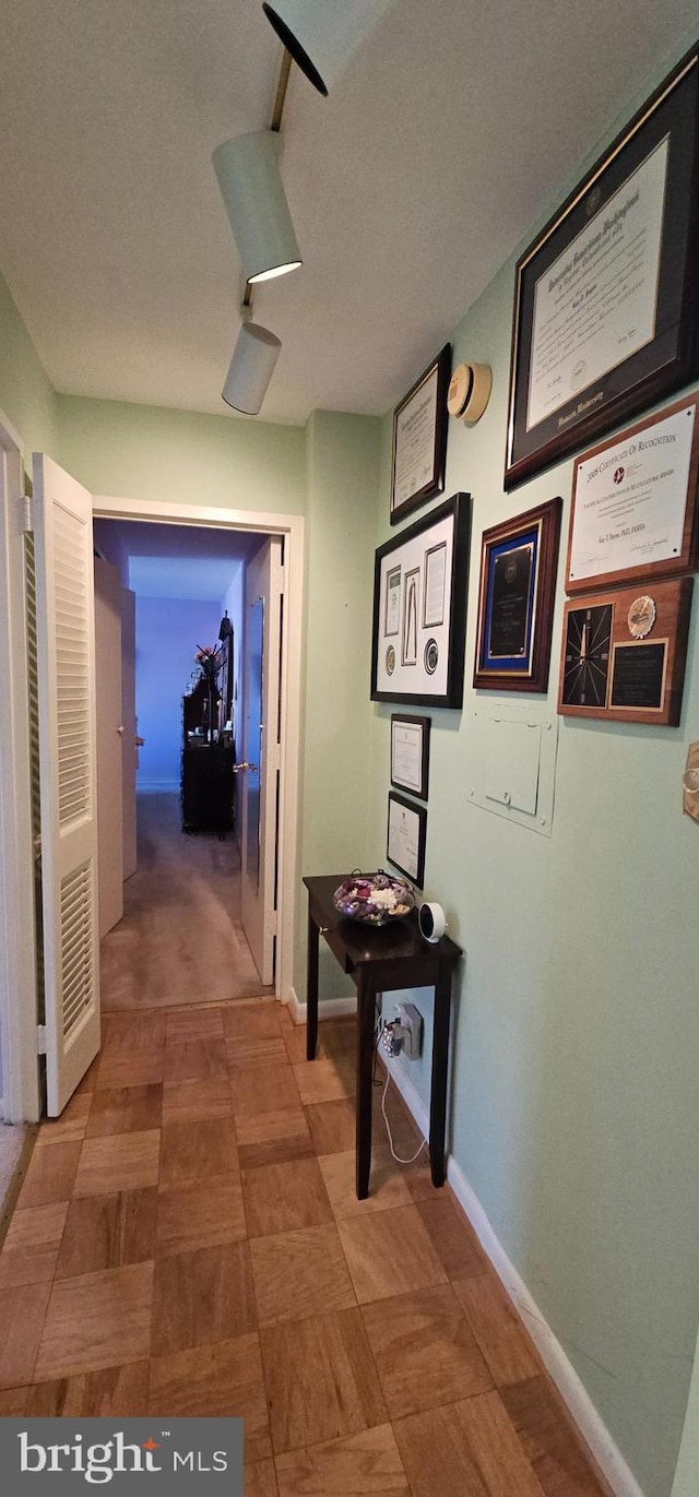 hallway with a textured ceiling