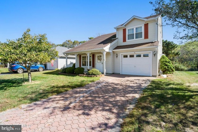 view of front property with covered porch, a front yard, and a garage