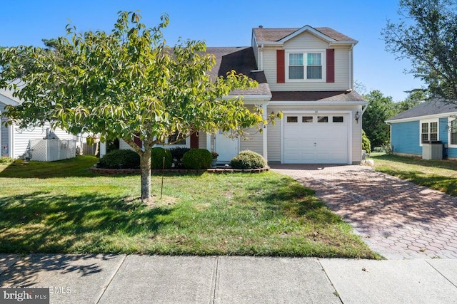 view of front of house featuring a garage and a front lawn