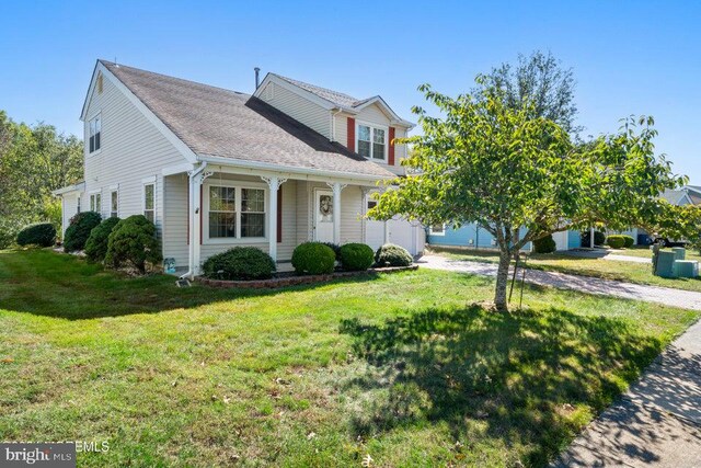 view of front of home with a porch and a front yard