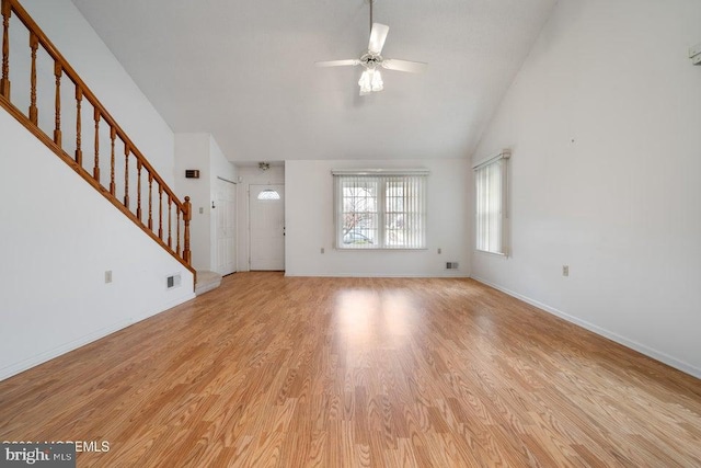 unfurnished living room with ceiling fan, light hardwood / wood-style floors, and vaulted ceiling