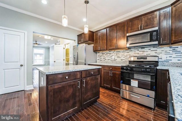 kitchen featuring dark brown cabinetry, light stone countertops, decorative light fixtures, and appliances with stainless steel finishes