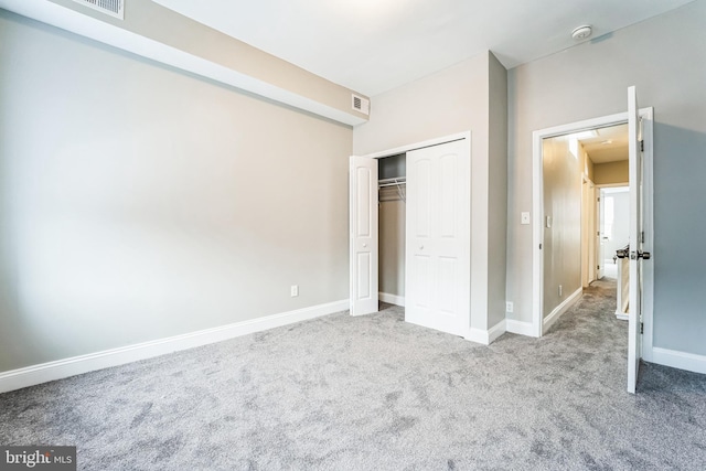 unfurnished bedroom featuring carpet floors and a closet