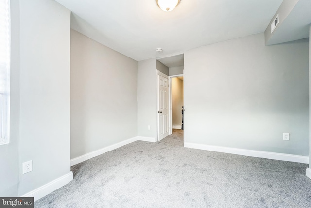 unfurnished room featuring light colored carpet