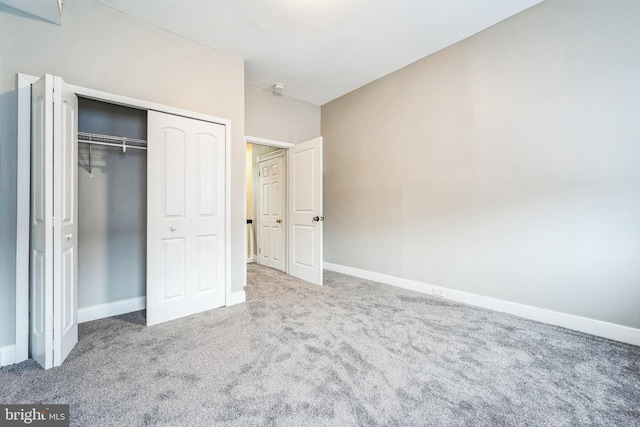 unfurnished bedroom featuring carpet floors and a closet