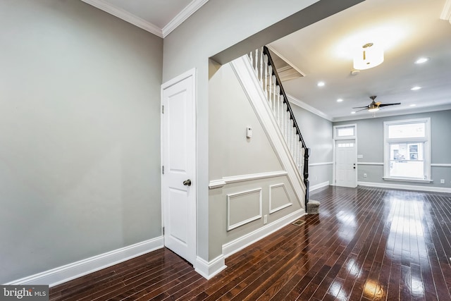 foyer entrance featuring ceiling fan, dark hardwood / wood-style floors, and ornamental molding