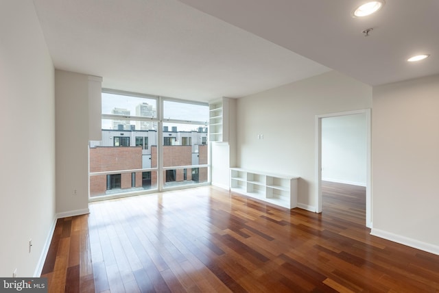 unfurnished living room featuring dark hardwood / wood-style flooring