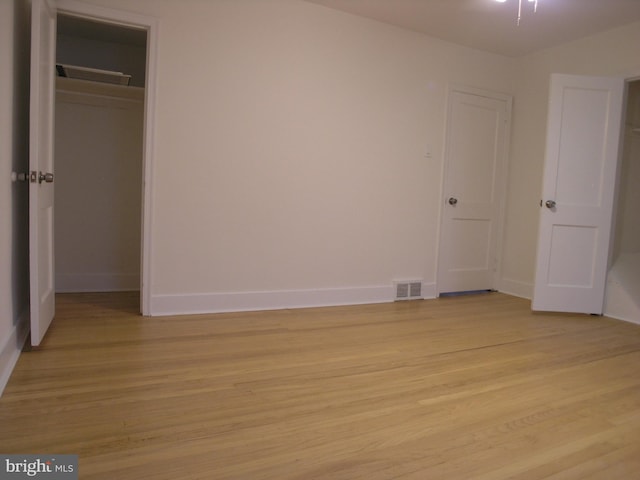 unfurnished bedroom with a closet and light hardwood / wood-style flooring