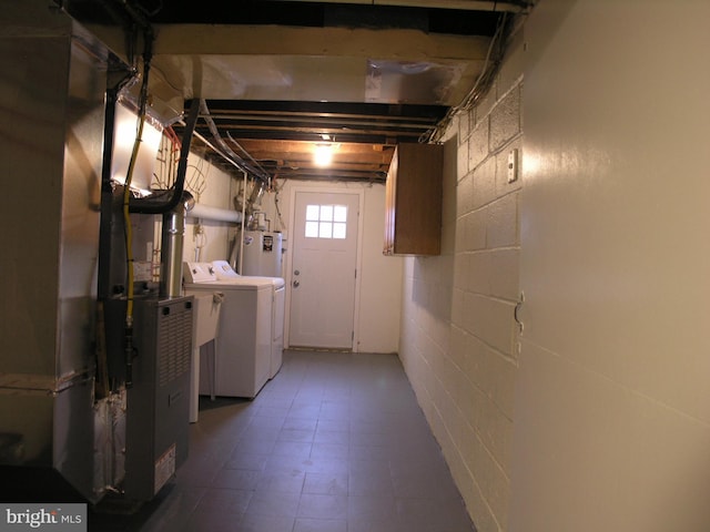 basement featuring washing machine and clothes dryer and gas water heater