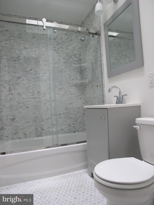 full bathroom featuring tile patterned flooring, vanity, toilet, and enclosed tub / shower combo