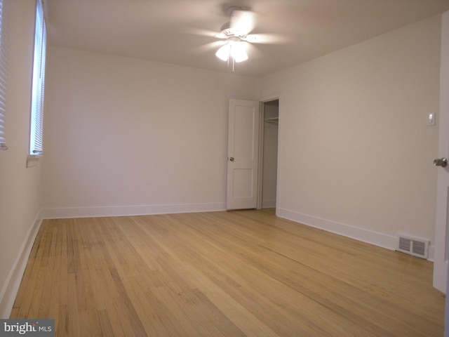 spare room with ceiling fan and light wood-type flooring