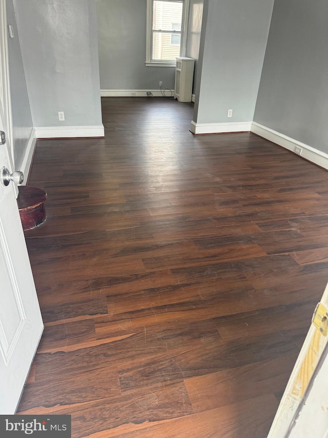 empty room featuring dark hardwood / wood-style flooring