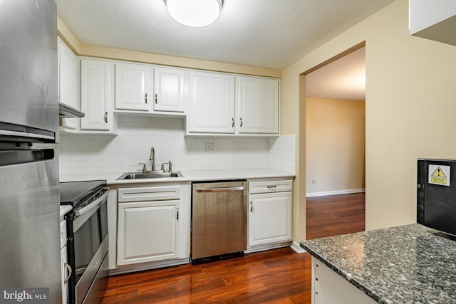 kitchen with stainless steel appliances, white cabinetry, dark wood-type flooring, and sink