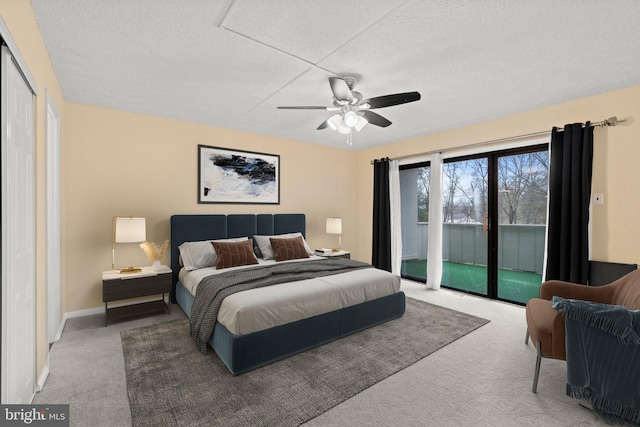 carpeted bedroom featuring ceiling fan, a textured ceiling, and access to outside